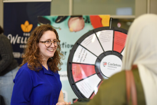 Registered Dietitian Talia Klein speaks with a student at a Wellness Event.